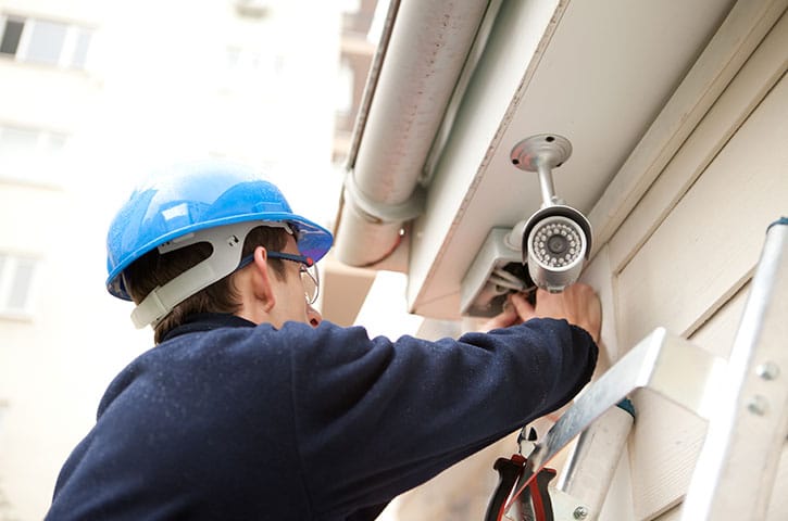 Man installing security camera for Cannabis Security